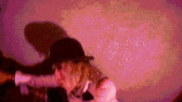 a pixelated image of a woman in a baseball cap