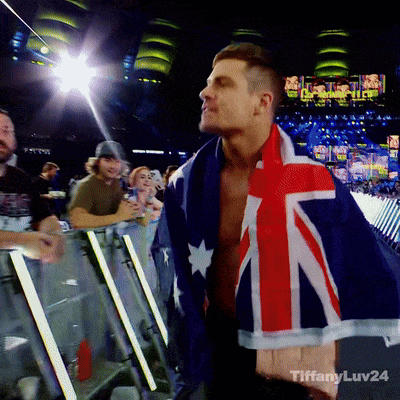 a man wrapped in an australian flag stands in front of a crowd with tiffanyluv24 written on the bottom