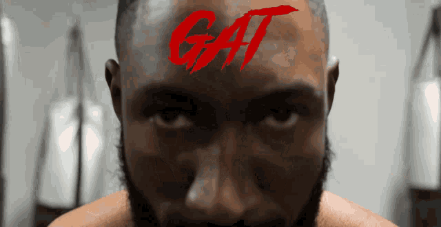 a close up of a man with the word gat on his forehead