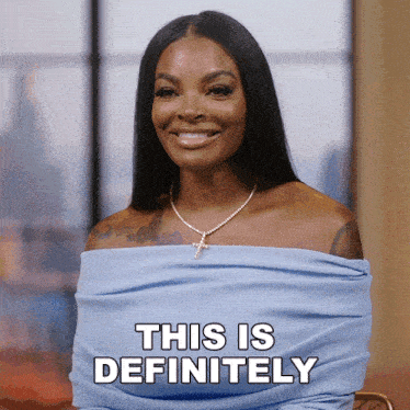 a woman wearing a blue off the shoulder top smiles and says " this is definitely "