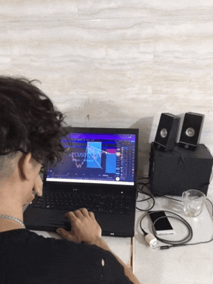 a man is looking at a laptop with a graph on the screen that says cuso