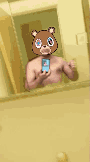 a shirtless man is taking a selfie with a teddy bear mask on his head