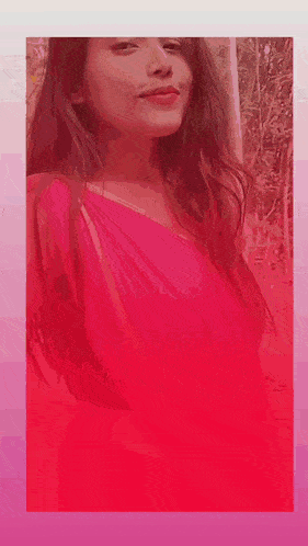 a woman in a pink dress is standing in front of a pink background