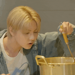 a man is pouring something into a pot with the number 3 and 4 written on the bottom