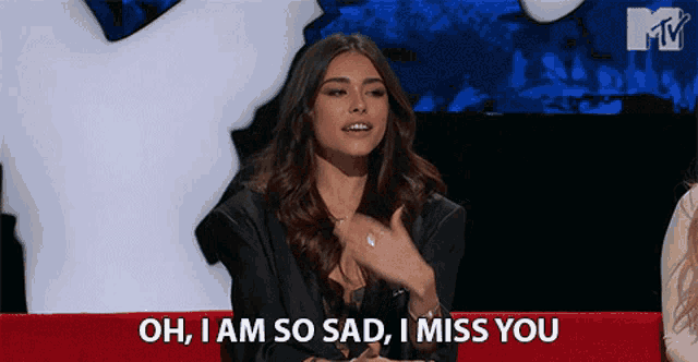 a woman sitting on a couch with the words oh i am so sad i miss you above her