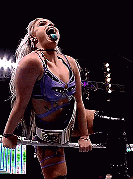 a woman in a wrestling ring with a belt that says liv