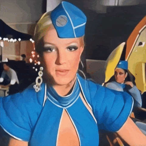 a woman in a blue stewardess outfit with a blue hat on her head