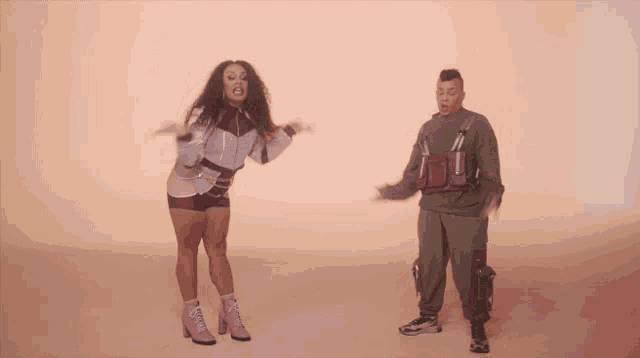 a man and a woman are dancing together and the woman is wearing a purple outfit