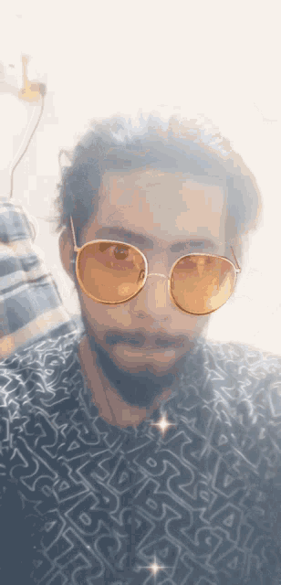 a man wearing sunglasses and a shirt that has the letter a on it