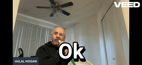 a man brushing his teeth in front of a mirror with the word ok on the bottom