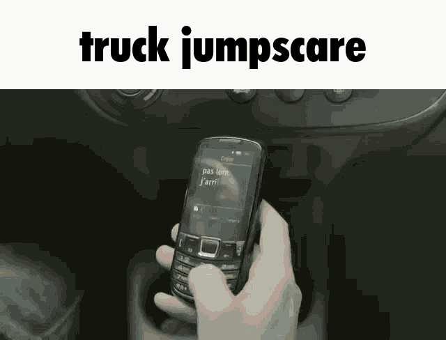 a person holding a cell phone with the words truck jumpscare written above it