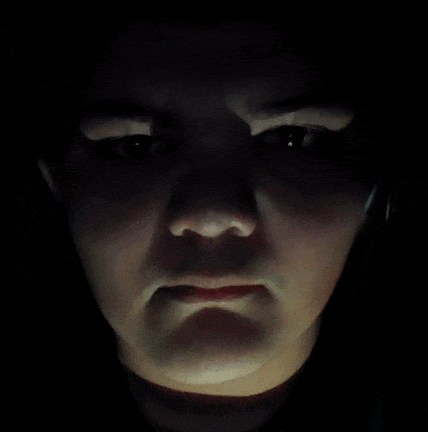 a close up of a person 's face with a serious look on their face
