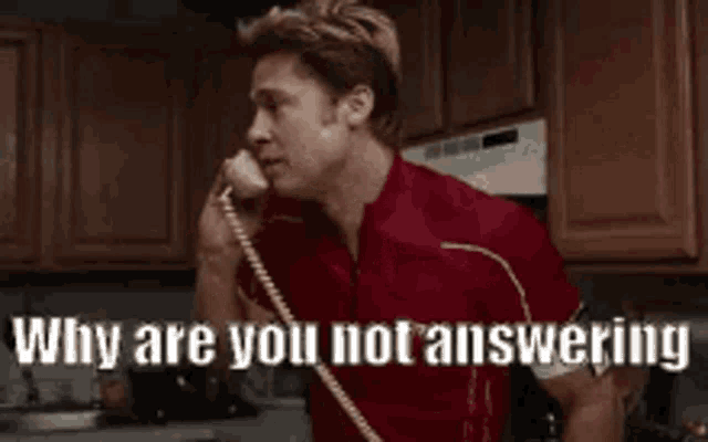 a man is talking on a telephone in a kitchen and says `` why are you not answering '' .