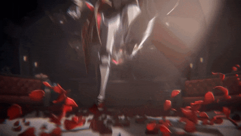 a blurred image of a person standing in a room surrounded by red petals