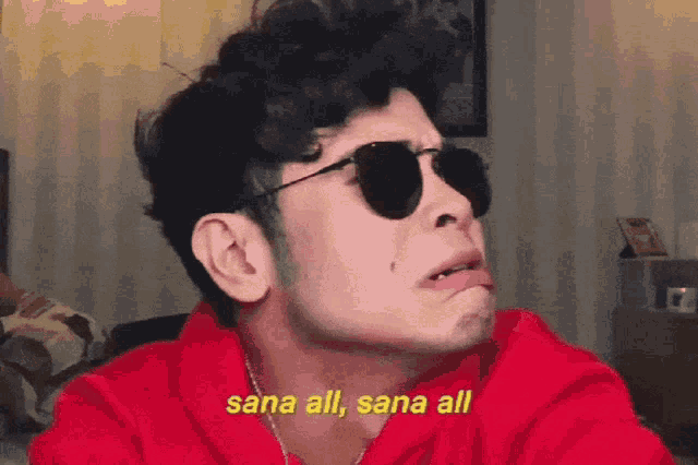 a man wearing sunglasses says sana all