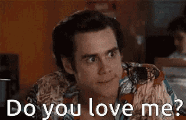 a man in a hawaiian shirt is asking if someone loves him .