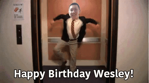 a man in a suit and tie is dancing in an elevator with the words happy birthday wesley written below him