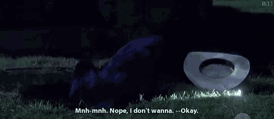 a man in a cowboy hat is laying in the grass and talking