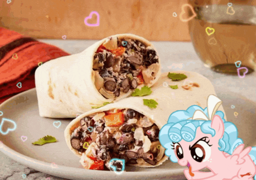 a burrito on a plate with a cartoon pony standing next to it