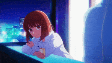 a girl in a hoodie is looking out of a window at night