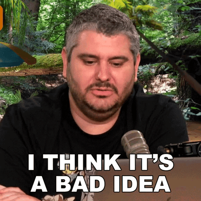 a man sitting in front of a microphone with the words " i think it 's a bad idea "