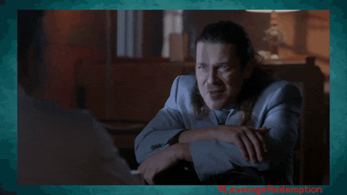 a man in a suit is talking to another man in a frame that says leverage redemption on it