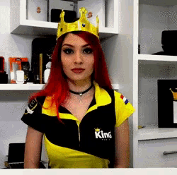 a woman wearing a king shirt and a crown on her head