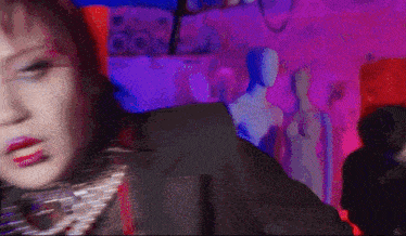 a blurry picture of a woman in a suit with a purple background