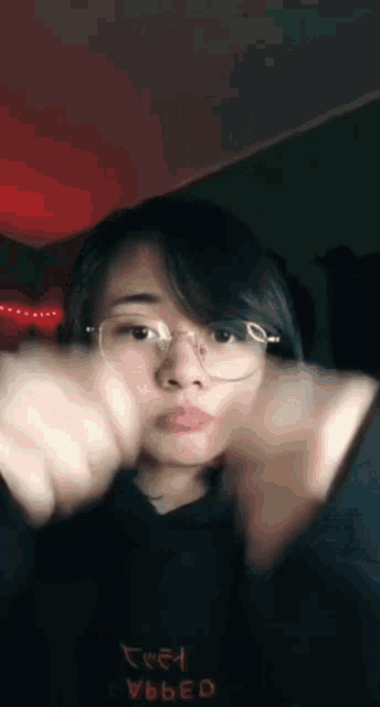 a girl wearing glasses and a black hoodie that says free video