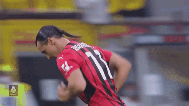 a soccer player with the number 11 on his jersey is running
