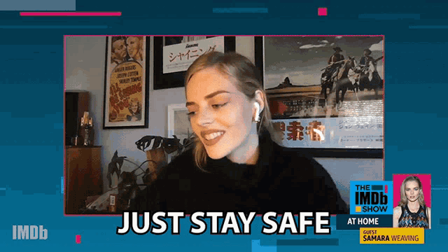 a woman is smiling in front of a screen that says just stay safe at home