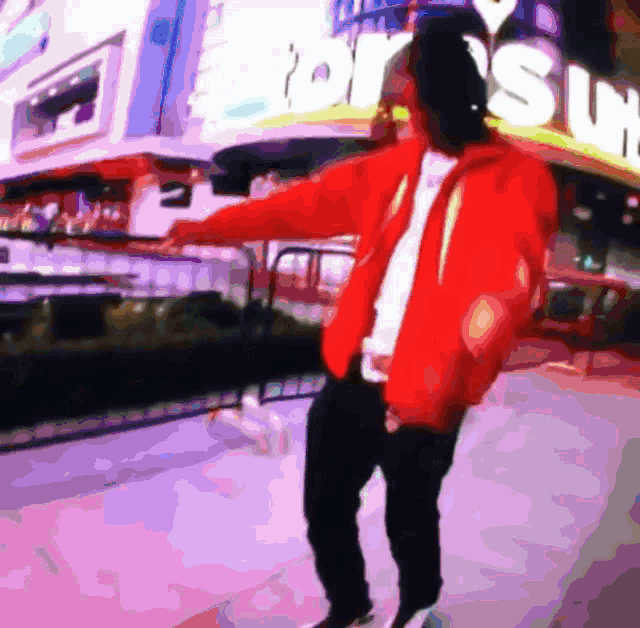 a man in a red jacket is dancing in front of a sign that says ' supreme '