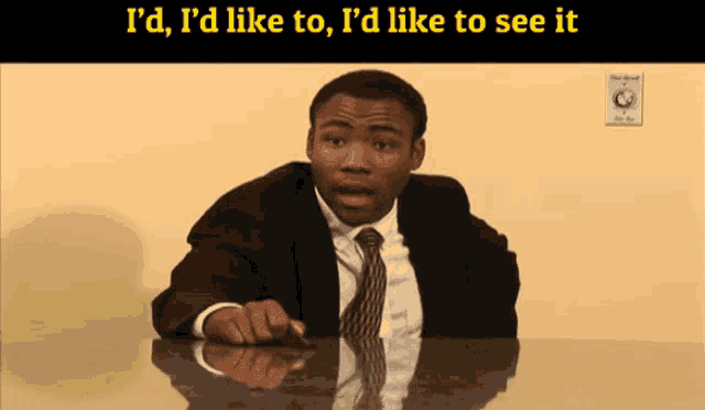 a man in a suit and tie sitting at a desk with the words i 'd like to i 'd like to