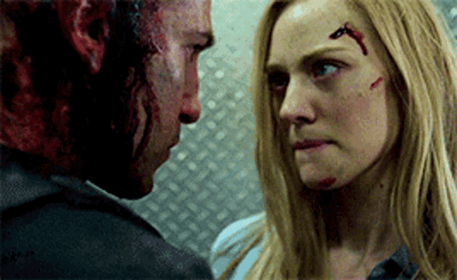 a man with blood on his face and a woman with blood on her face