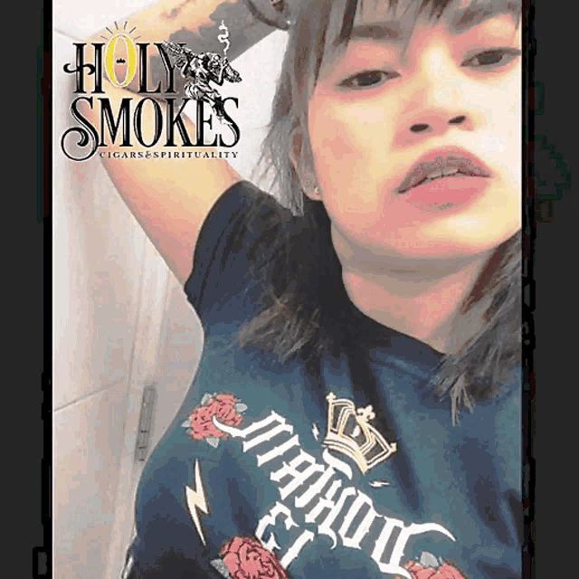 a woman is wearing a shirt that says holy smoke 's