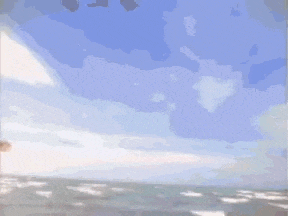 a woman is swimming in the ocean while holding a surfboard in her hand .