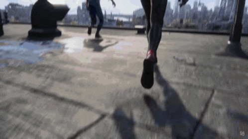 two people running on a rooftop with a city in the background and the letters gb on the bottom