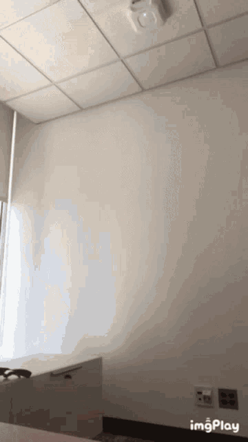 a room with a white wall and a ceiling that says ' imgplay ' on it