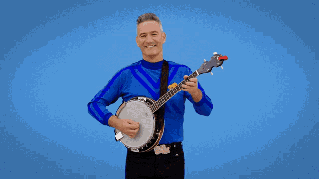 a man in a blue shirt holds a banjo