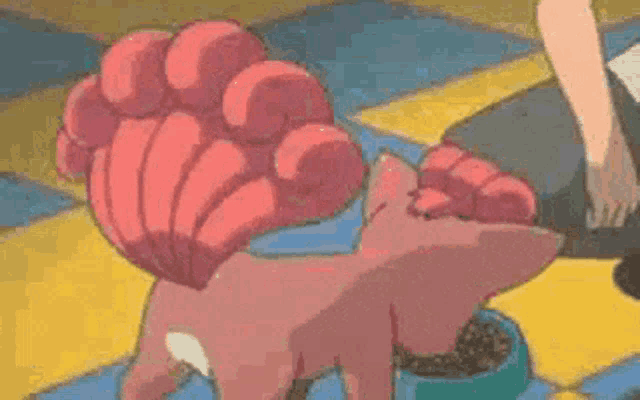 a pokemon is eating food from a blue bowl .