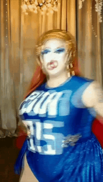 a drag queen wearing a blue shirt that says budweiser on it
