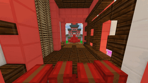 a screenshot of a minecraft game showing a red building with a tower in the background