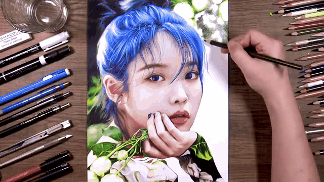 a drawing of a woman with blue hair is surrounded by pencils