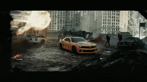 a yellow car with the word camaro on the front drives through a destroyed city