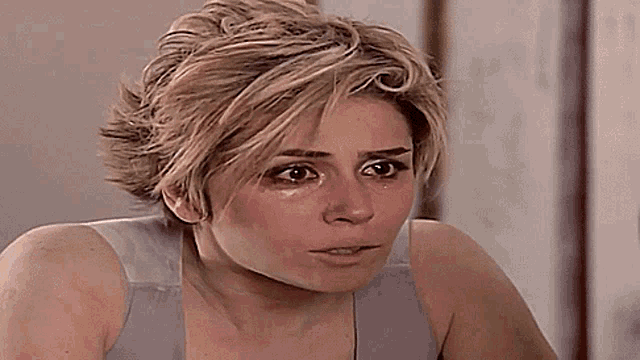 a close up of a woman 's face with a tear running down her cheek