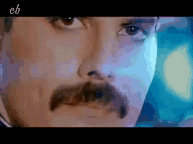 a close up of a man 's face with the letters cb on the bottom right