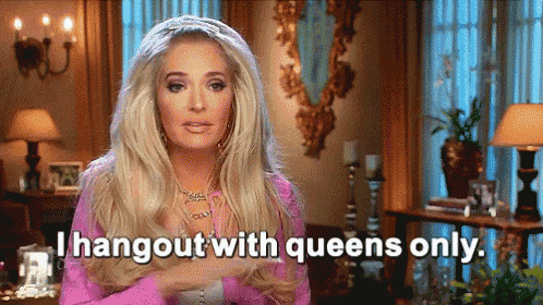 a woman in a pink dress is sitting in a living room and saying `` i hangout with queens only '' .
