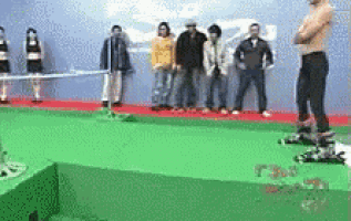 a group of people standing on a green carpet with a man standing in the middle