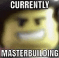 a blurred image of a lego man with the words `` currently masterbuilding '' .