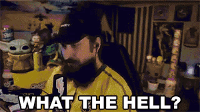 a man wearing a hat and a yellow shirt says what the hell ..